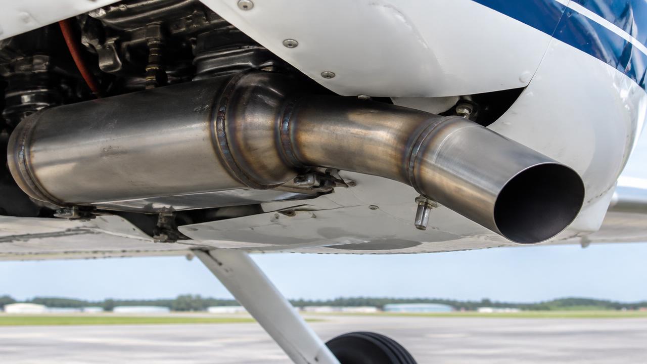 Exhaust muffler and tailpipe below the cowling